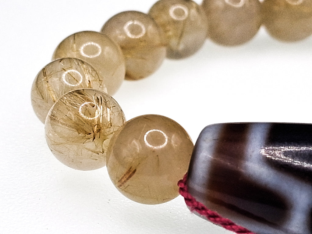 7-Eye Dzi — Rutilated Quartz Bracelet