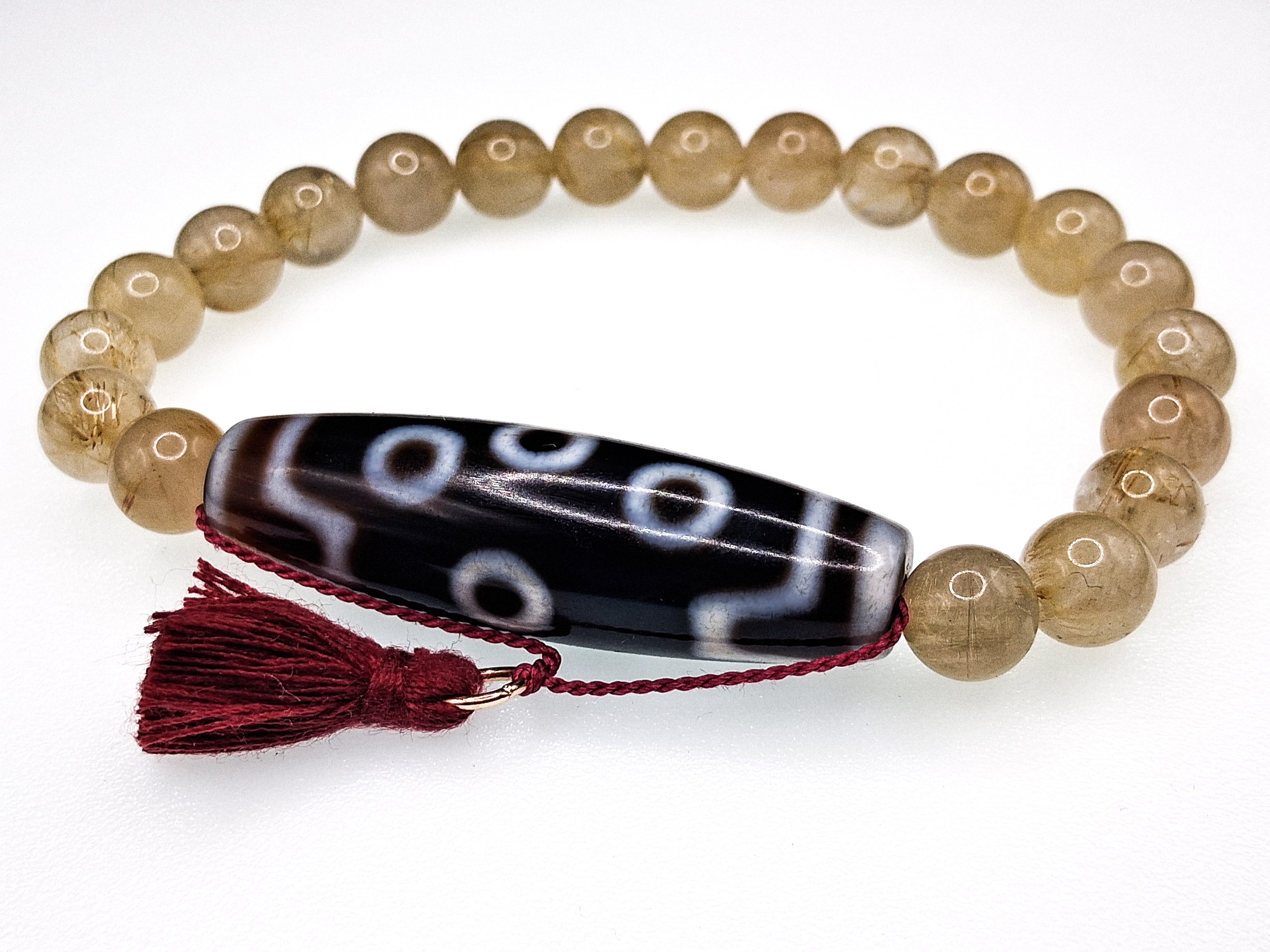 7-Eye Dzi — Rutilated Quartz Bracelet